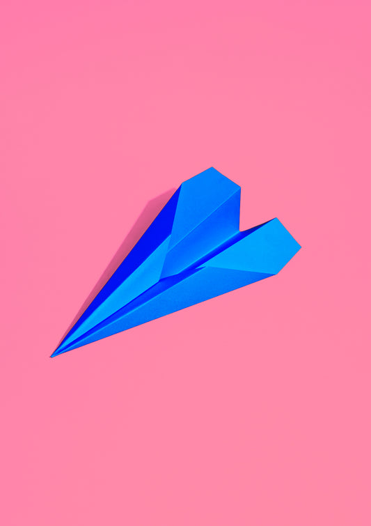 Royal blue paper plane on a pink background / Pop art style photo print