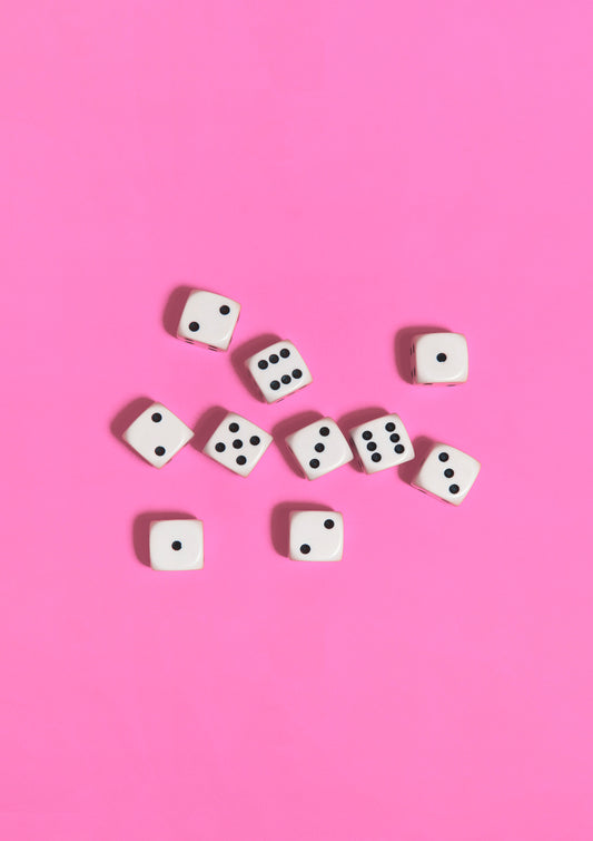 Black-and-white dices on a pink background / Pop art style photo print