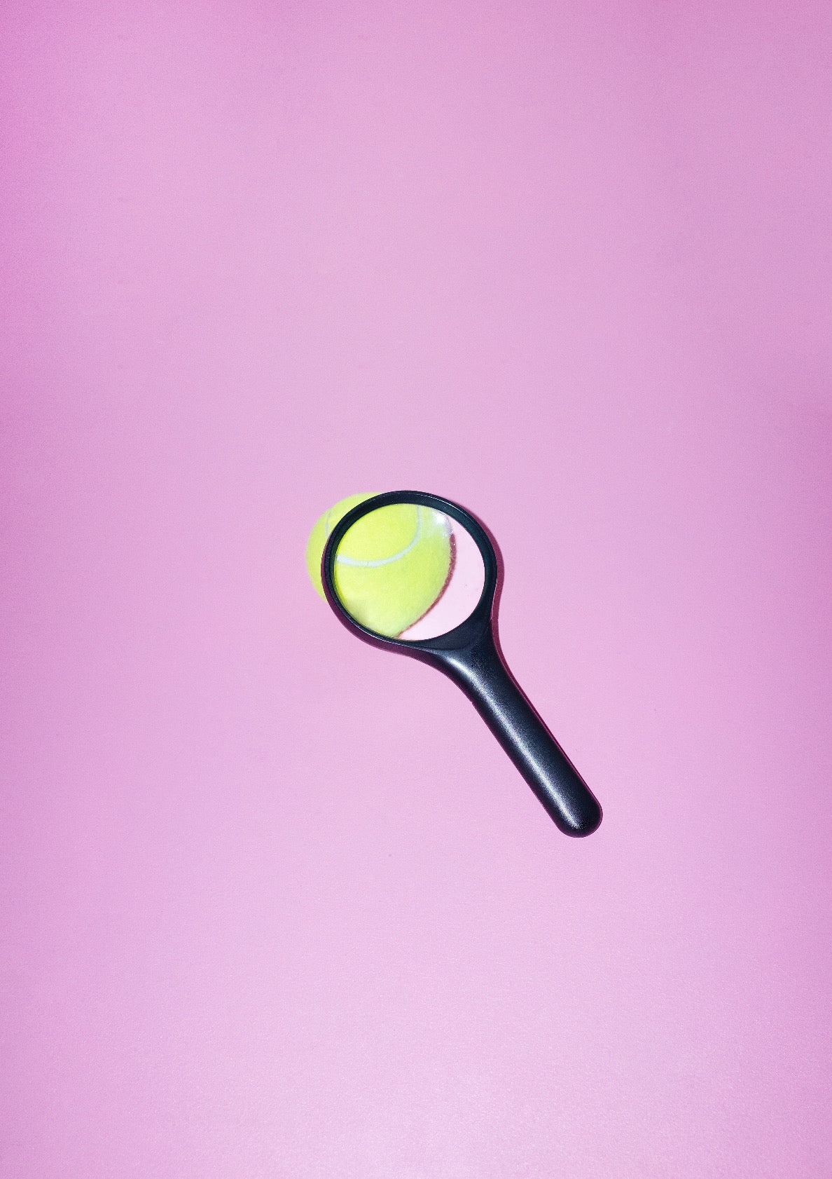 Magnifying glass and tennis ball