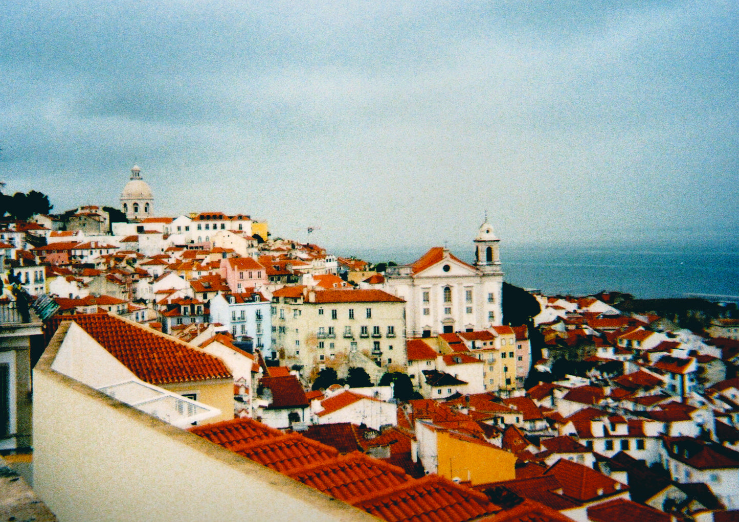 storm clouds above a sea of red roofs